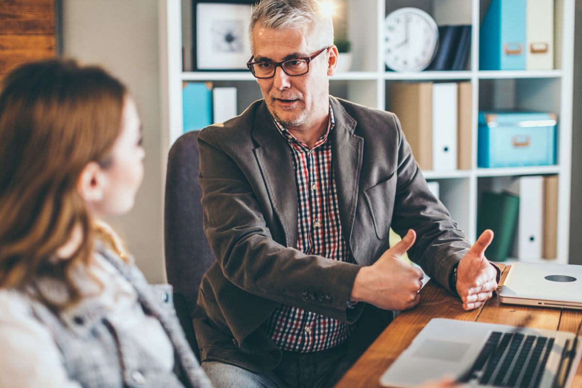 The photo shows reverse mentoring of two people.
