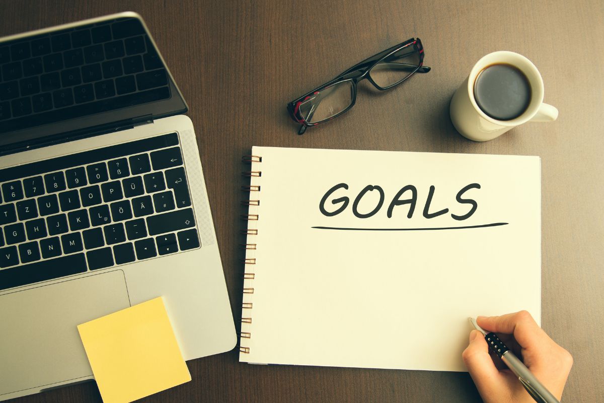 The picture is about a notebook with goal wording.