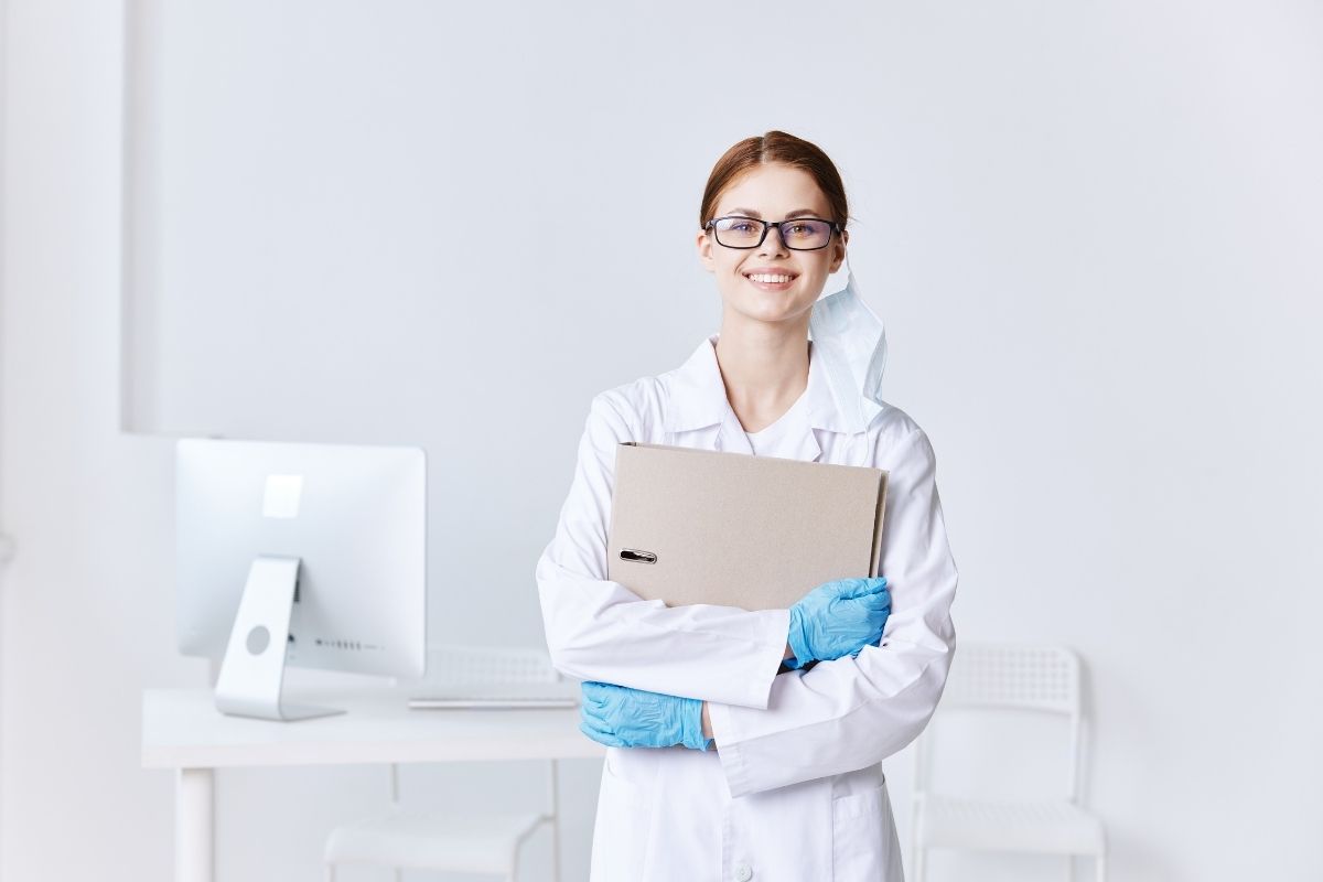 The image shows a woman working as a medical coder.