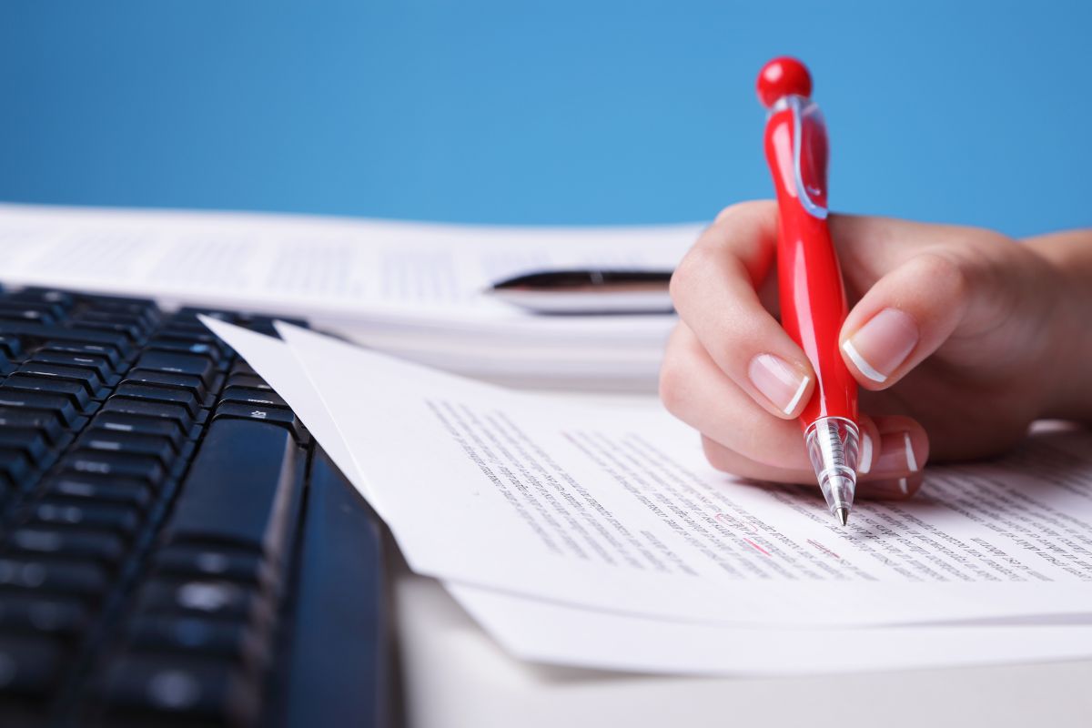 The photo of a lady's hand working as a copy editor.