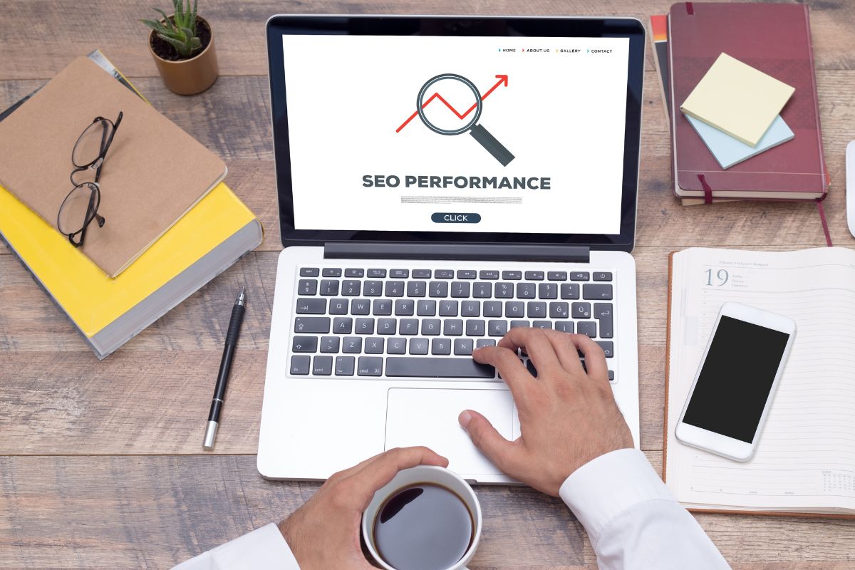 The picture shows a man's hand working as an SEO specialist.