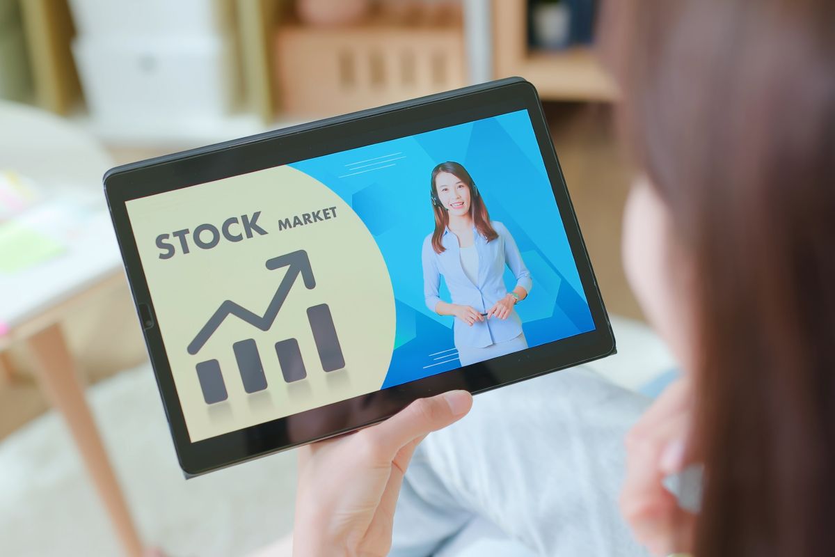 The image shows a woman learning basic investment terms.