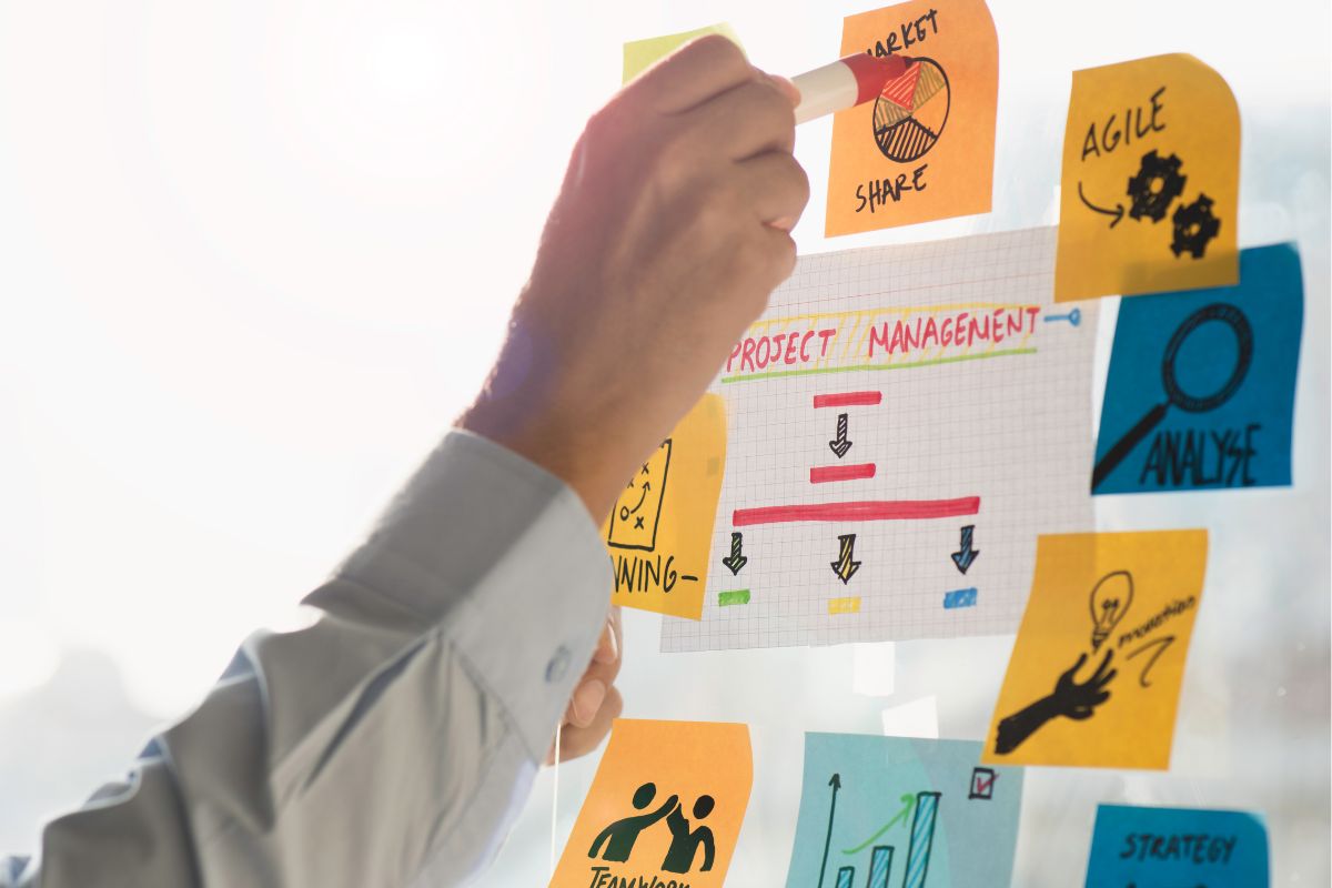 The picture shows a man's hand working as a project manager.