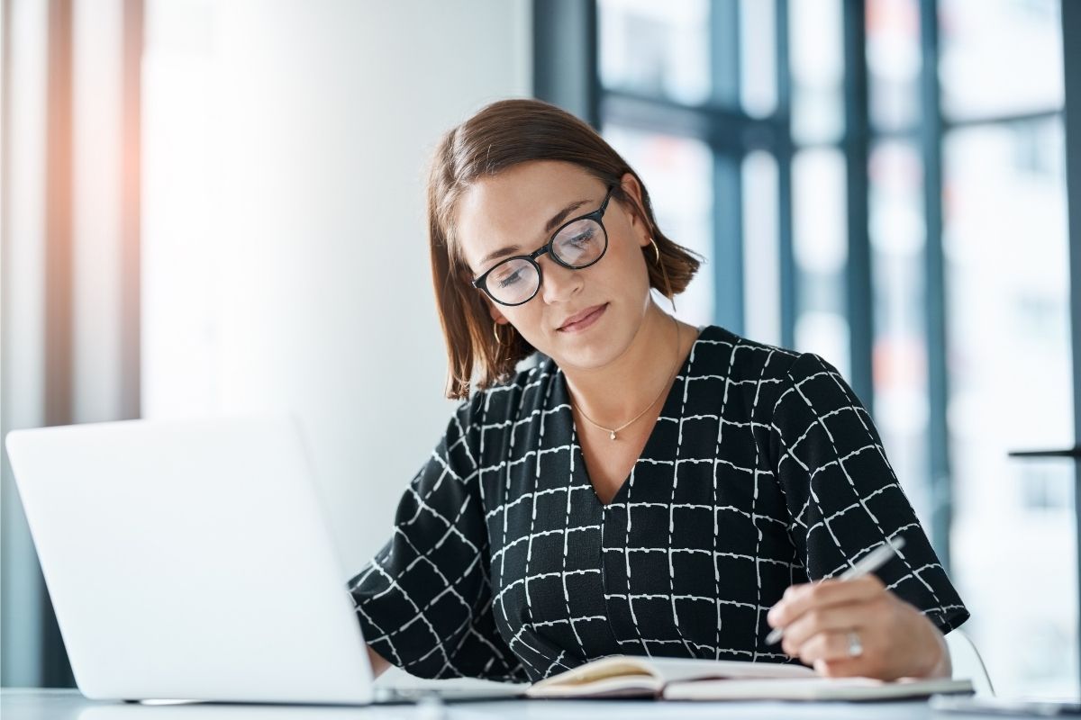 The image is about a woman working as a grant writer.