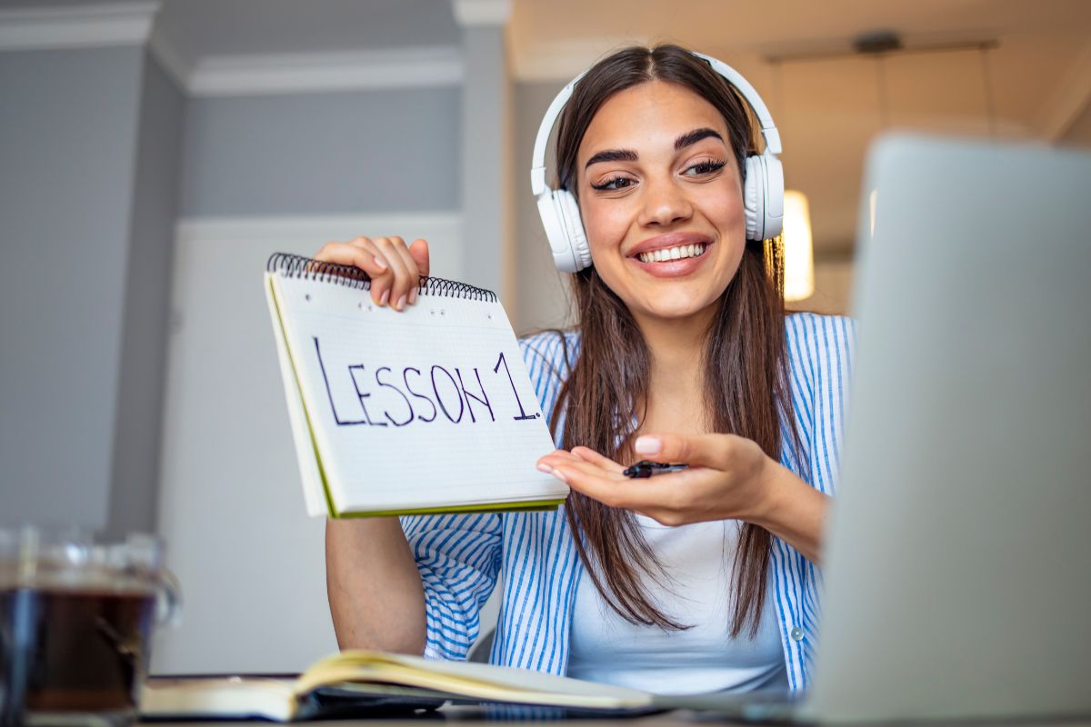 The photo shows a woman working as an online tutor.
