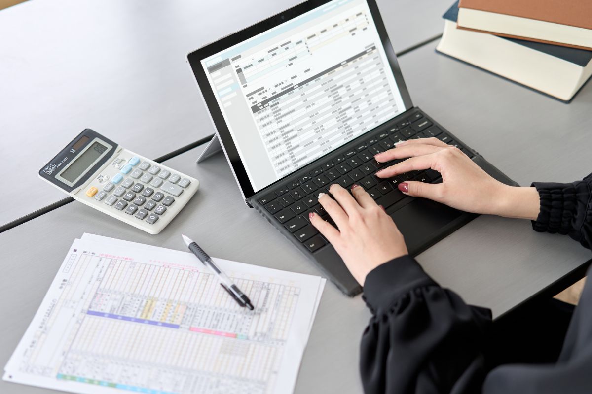 The photo shows a woman working as a data entry clerk.