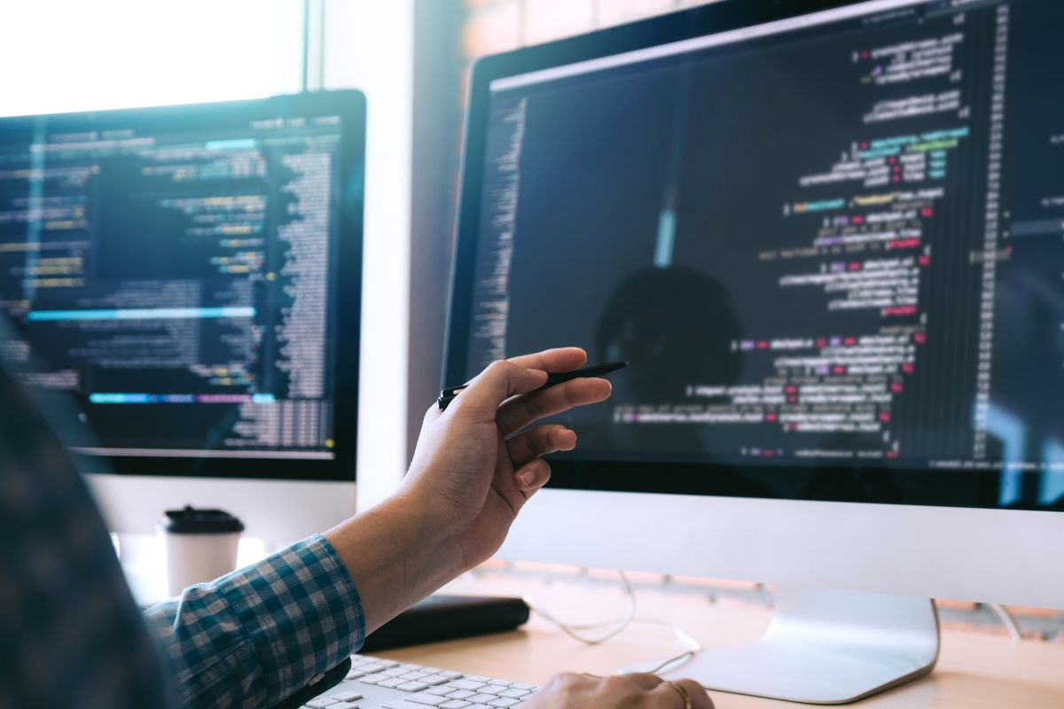 The picture is of a lady's hand working as a software engineer.