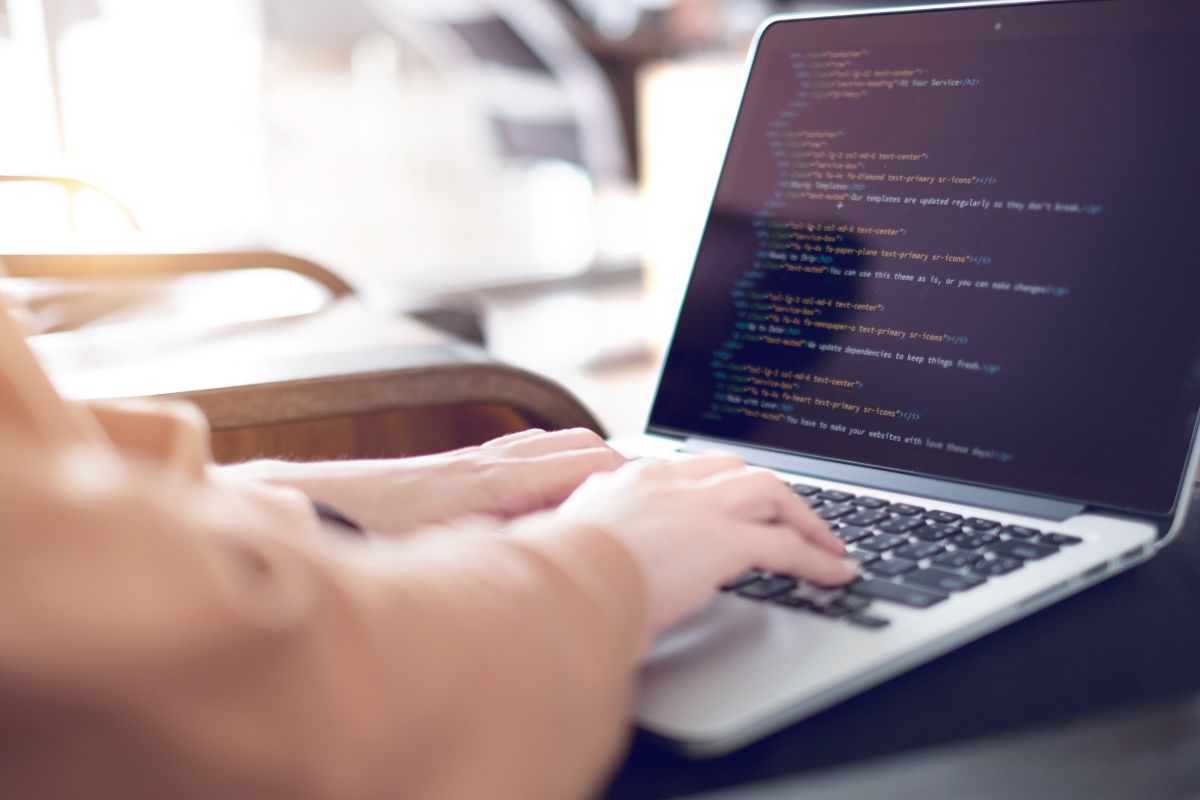 The image is about a woman working as a web developer.