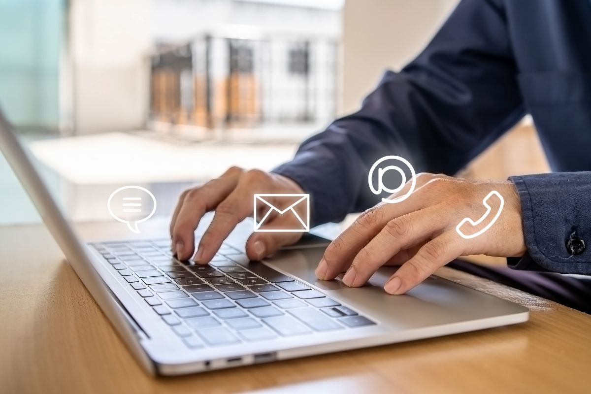 The photo of a man's hand working as a Chat support agent.