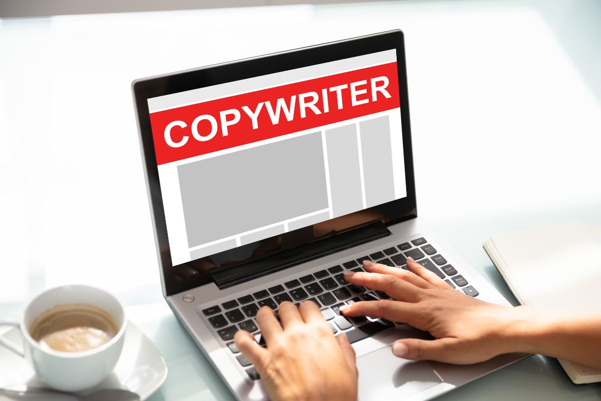 The image shows a young lady's hand working on a laptop as copywriting.