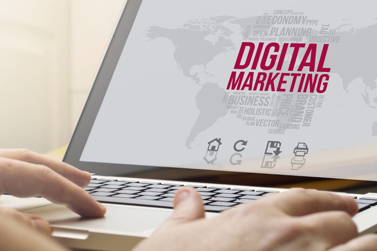 The image is about a woman's hand using a laptop for digital marketing.