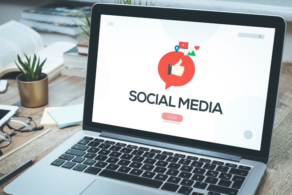 The image of a laptop with social media wording.