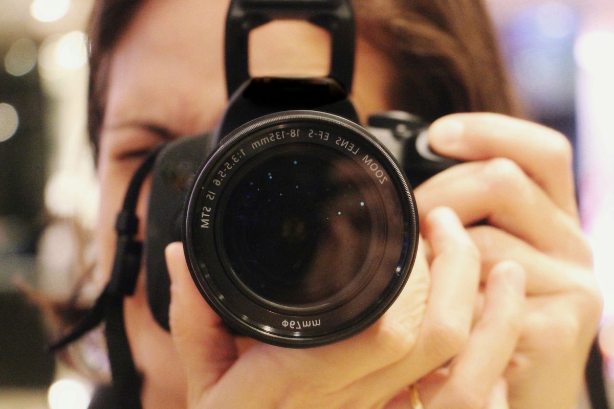 The image is about a lady doing photography.