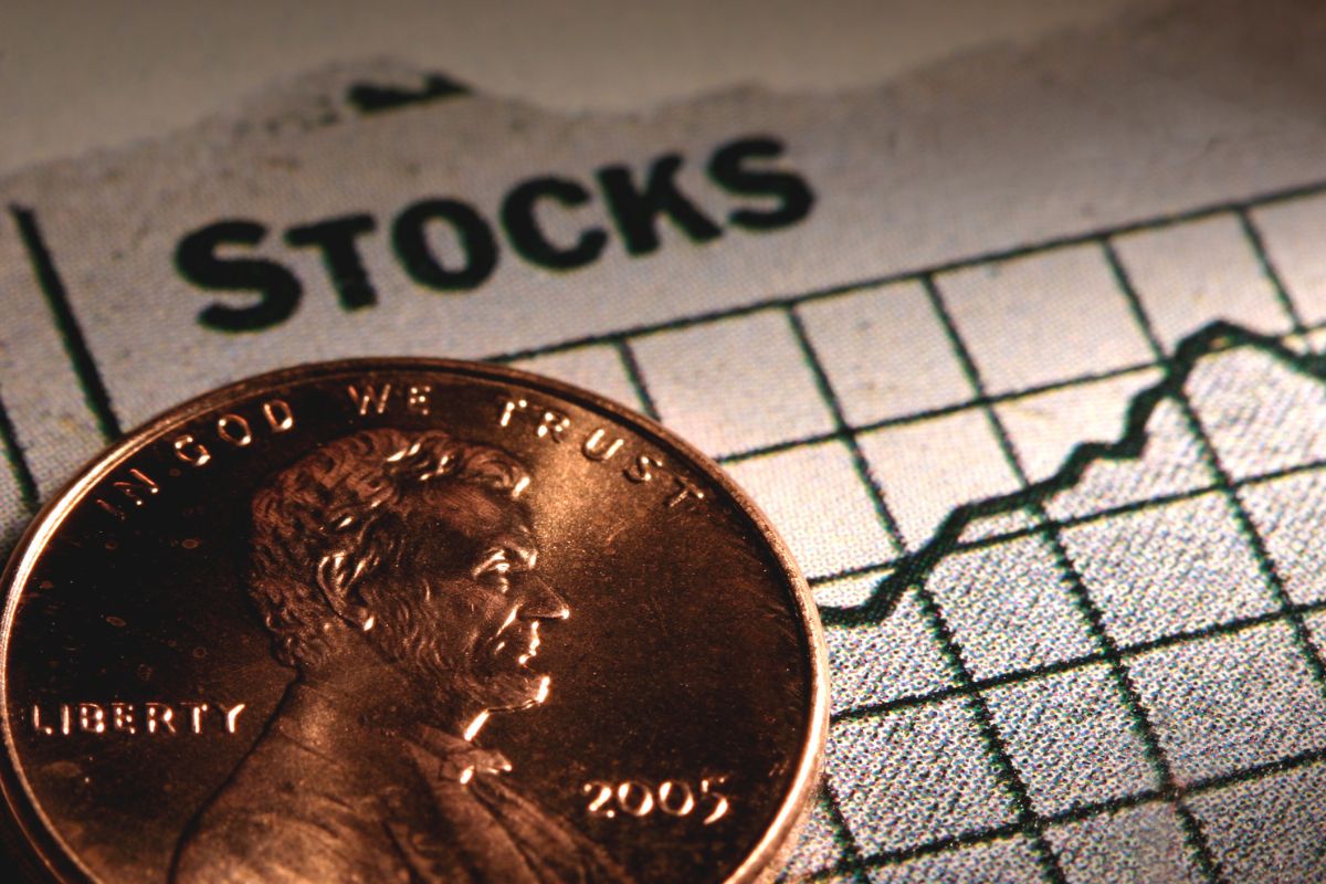 The picture shows a coin and paper with stock wording.