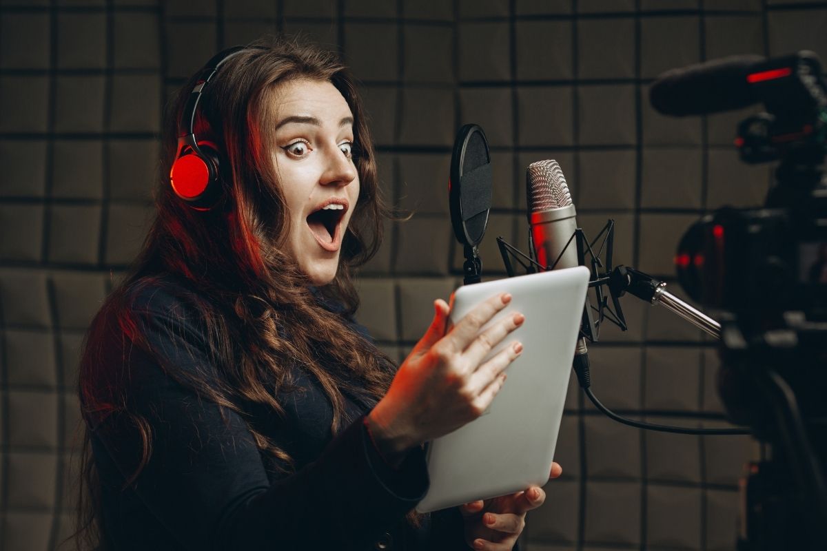The photo shows a lady voice acting.