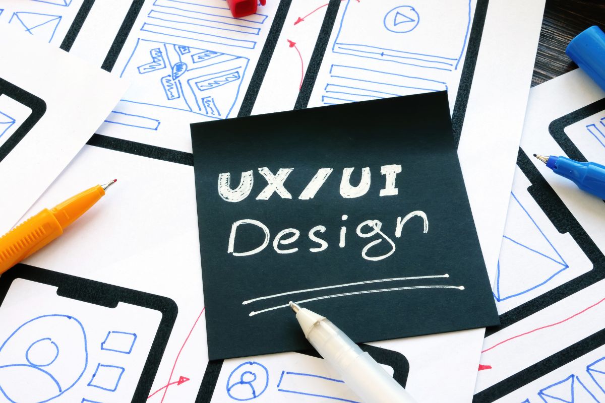 The picture shows a paper with UX/UI design wording.