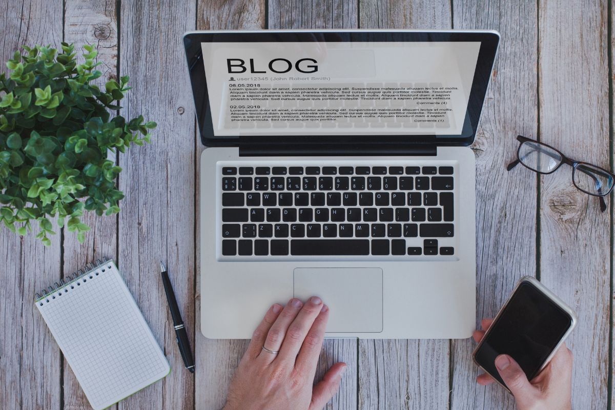 The picture shows a woman's hand working as a blogger.