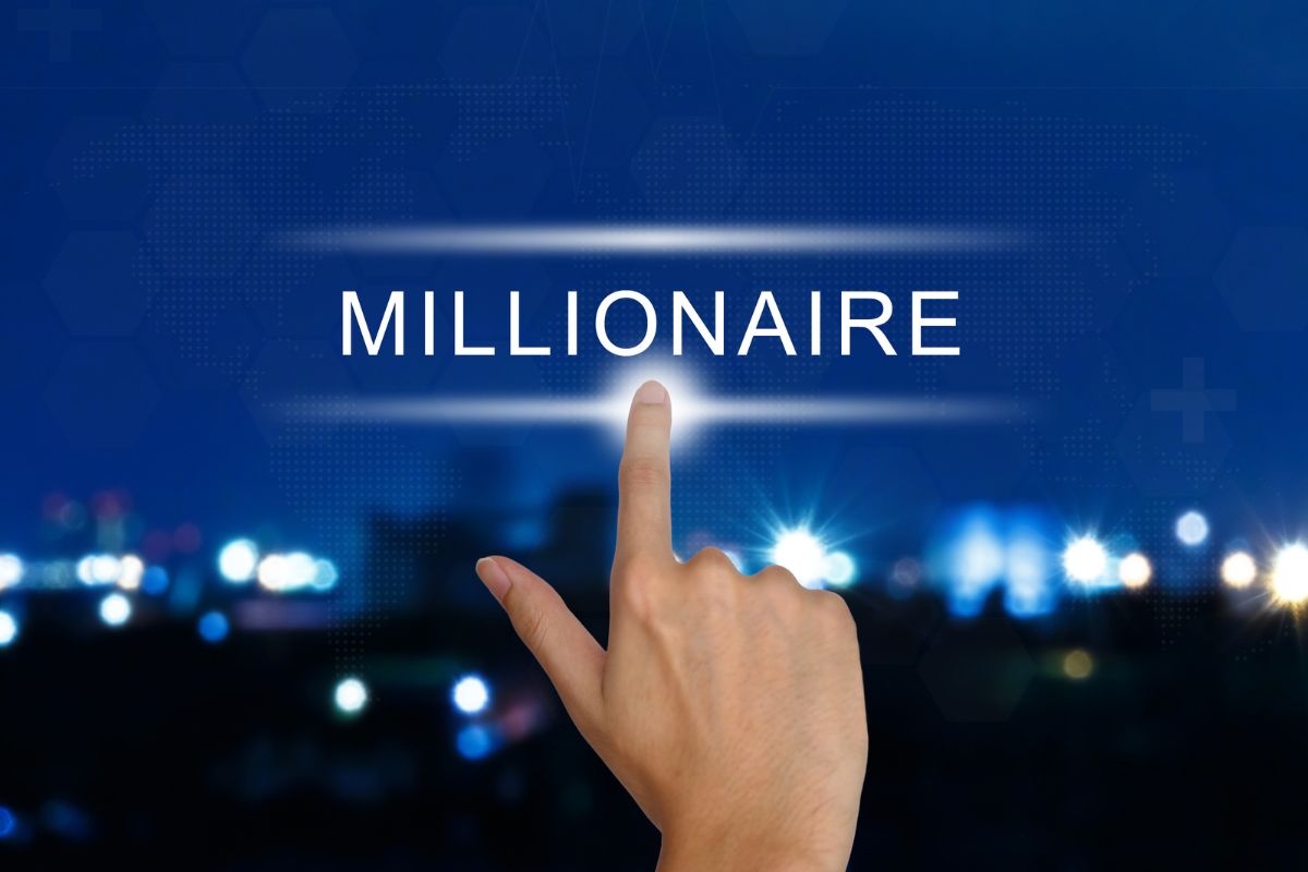 The picture shows a man's hand pointing to the millionaire wording.