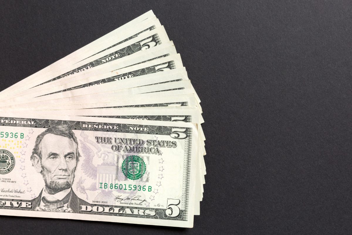 The photo is about a five-dollar bill savings challenge.