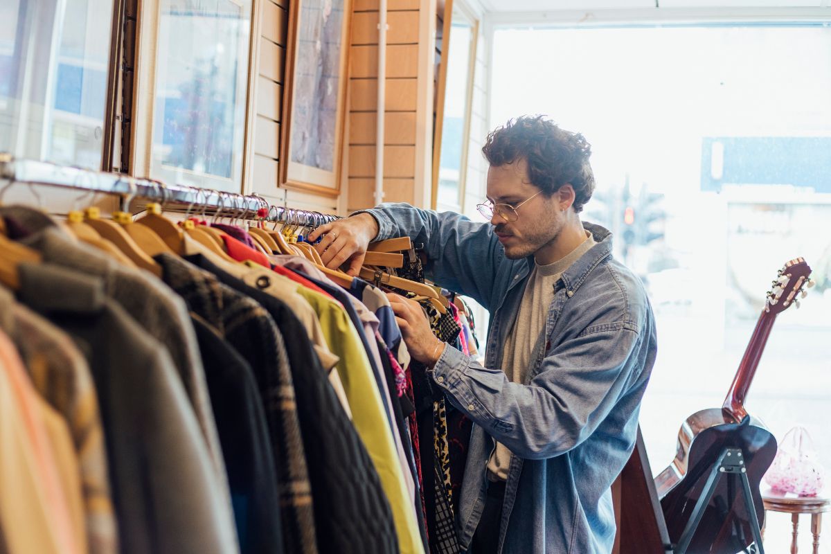 The image shows a man doing a thrift store treasure hunt.