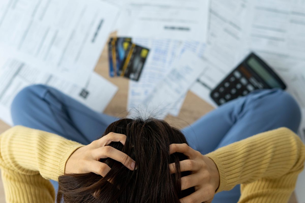 The picture shows a woman with behind bills.