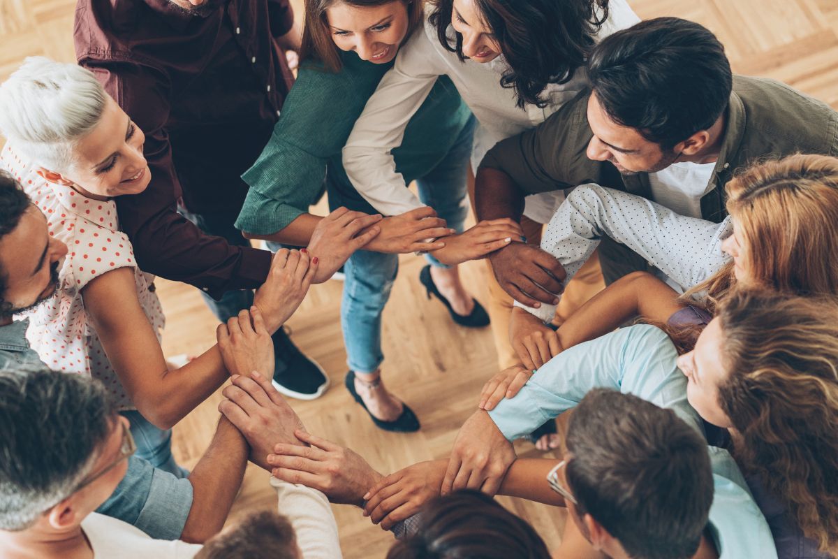 The photo shows a group of people surrounded by financially savvy people.