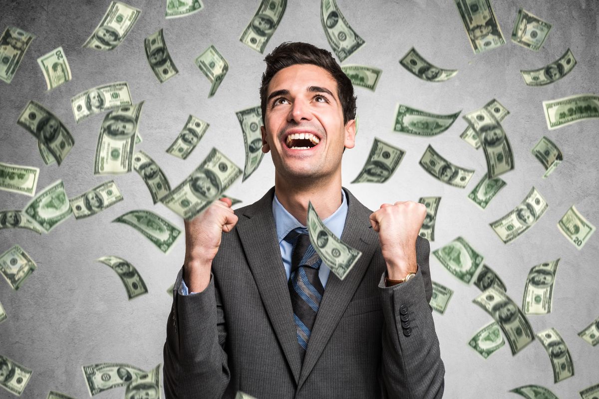 The photo shows a man with falling dollar bills to make himself a millionaire.