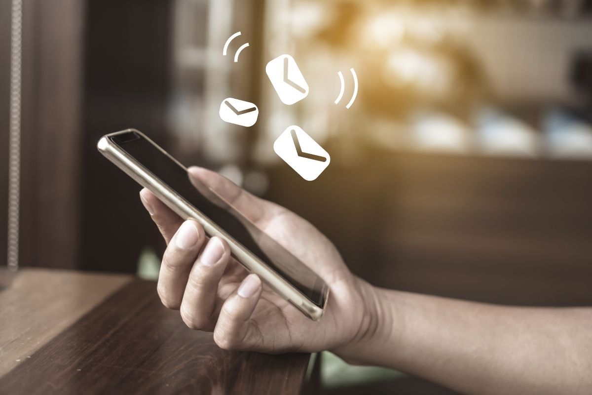 The picture is about a woman's hand checking the deposit received notification.