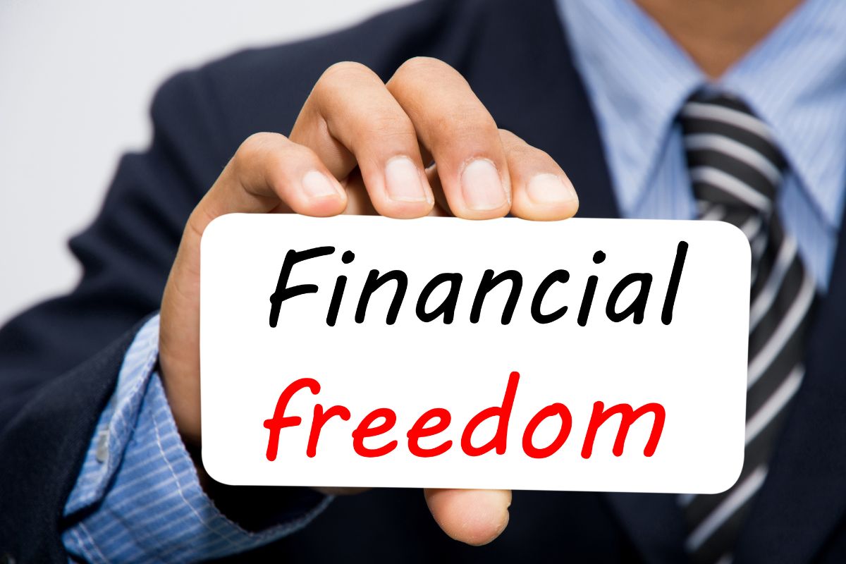 The picture shows a man with a piece of paper representing financial freedom.