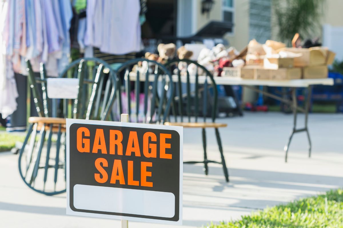 The photo shows items and garage sale signage.