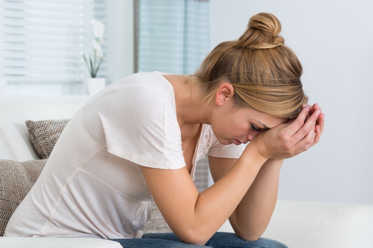 The image shows a stressed lady.
