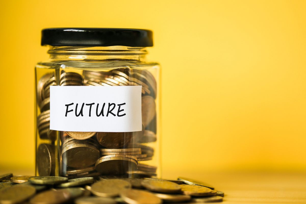 The photo shows a jar filled with coins for the future.