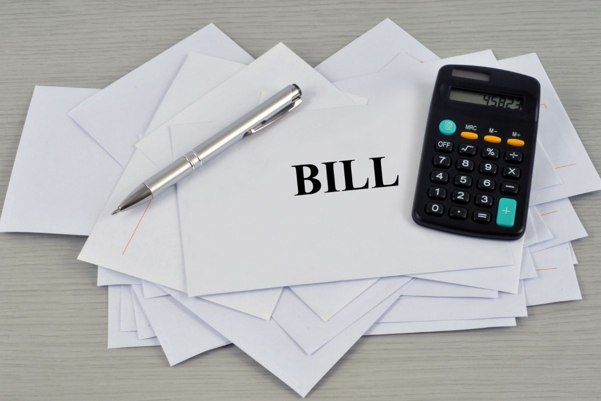 The image shows envelopes with a bill wording and a calculator.