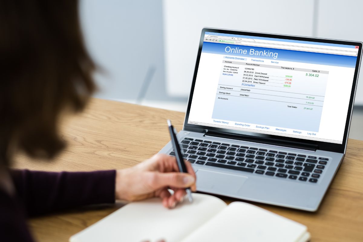 The picture shows a girl checking her online bank account.