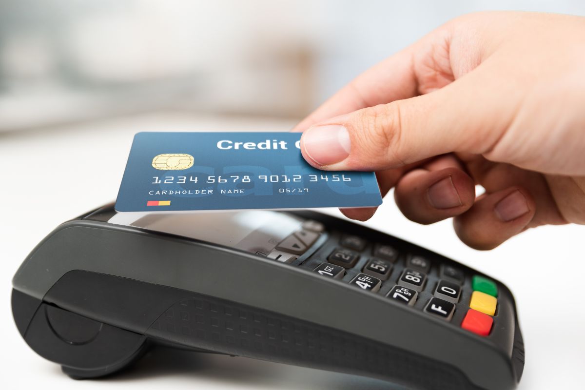 The image shows a lady's hand relying on credit cards.