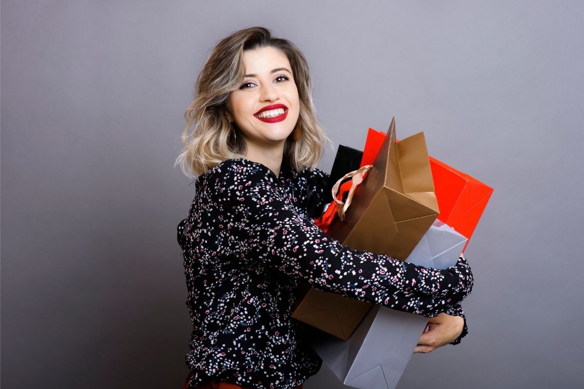 The image shows a woman shopping with impulse spending.