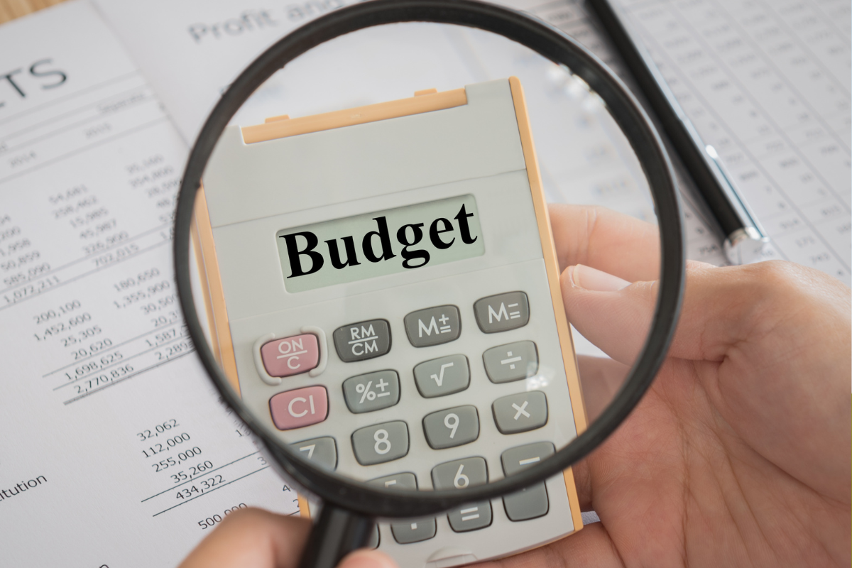 The picture shows a man's hand with no clear budget plan.