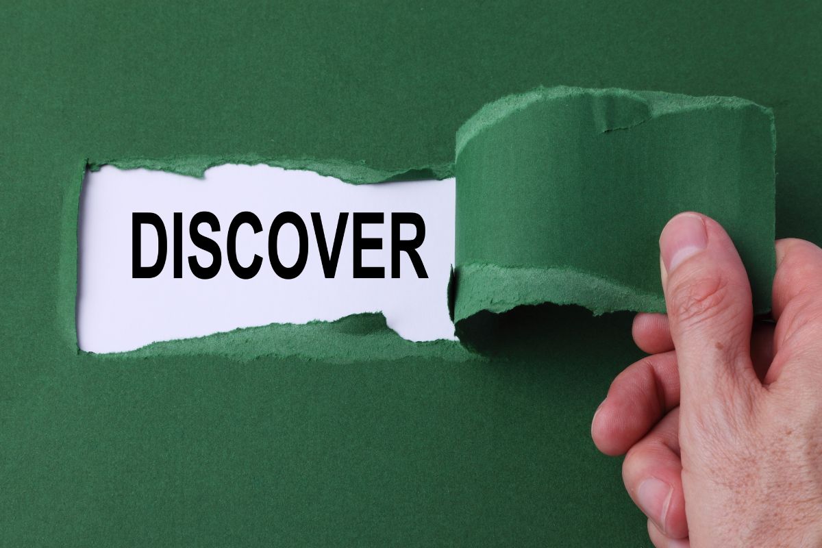The picture is about a man's hand tearing the paper with a discover note.