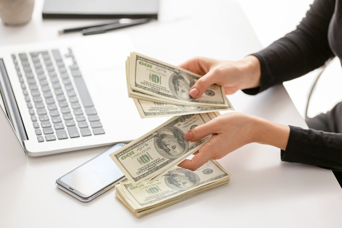The photo shows a lady's hand taking control of every dollar.