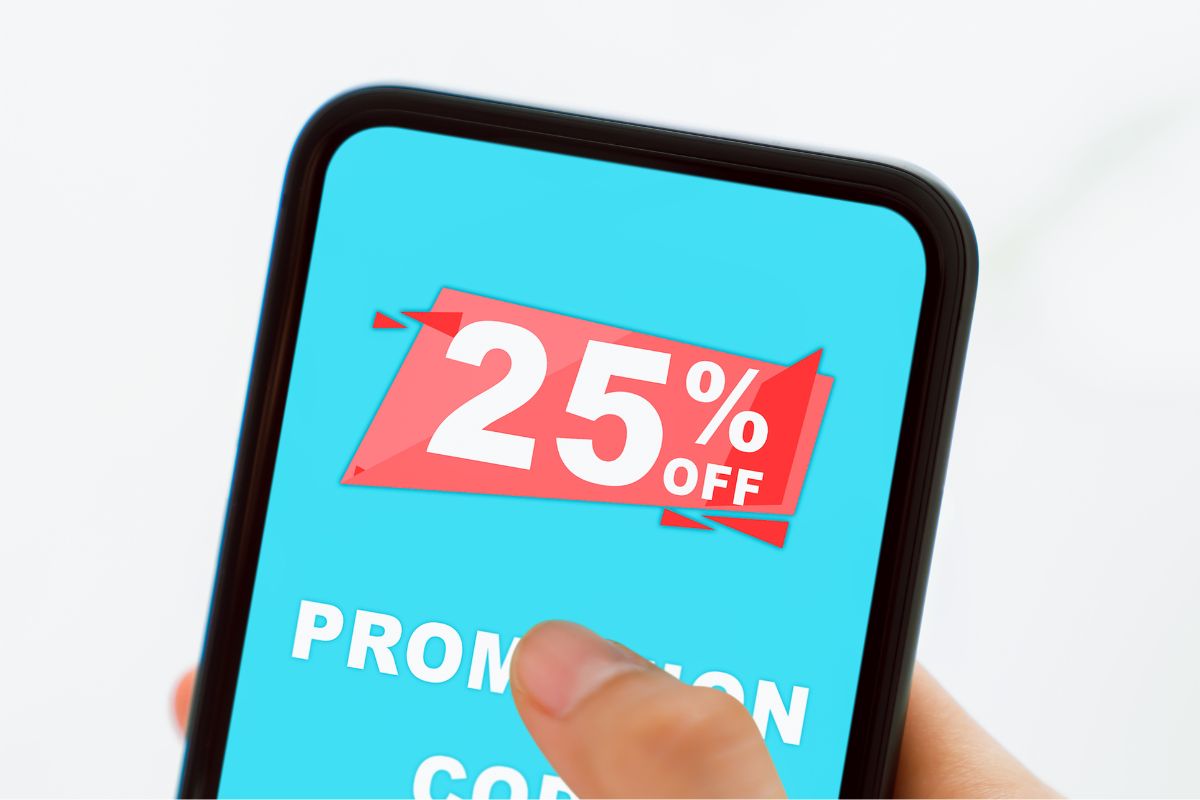 The image shows a woman's hand holding a phone with digital coupons.