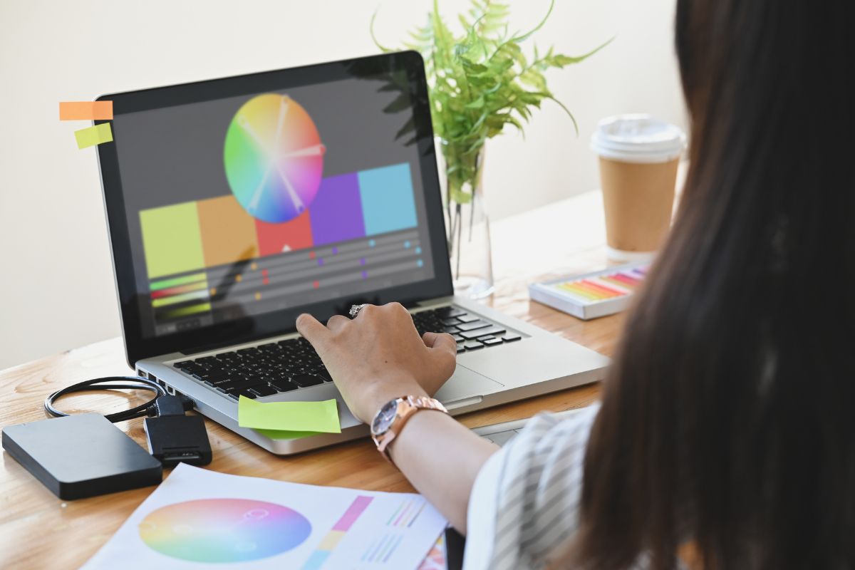 The image of a woman working on her laptop as a freelance graphic designer.