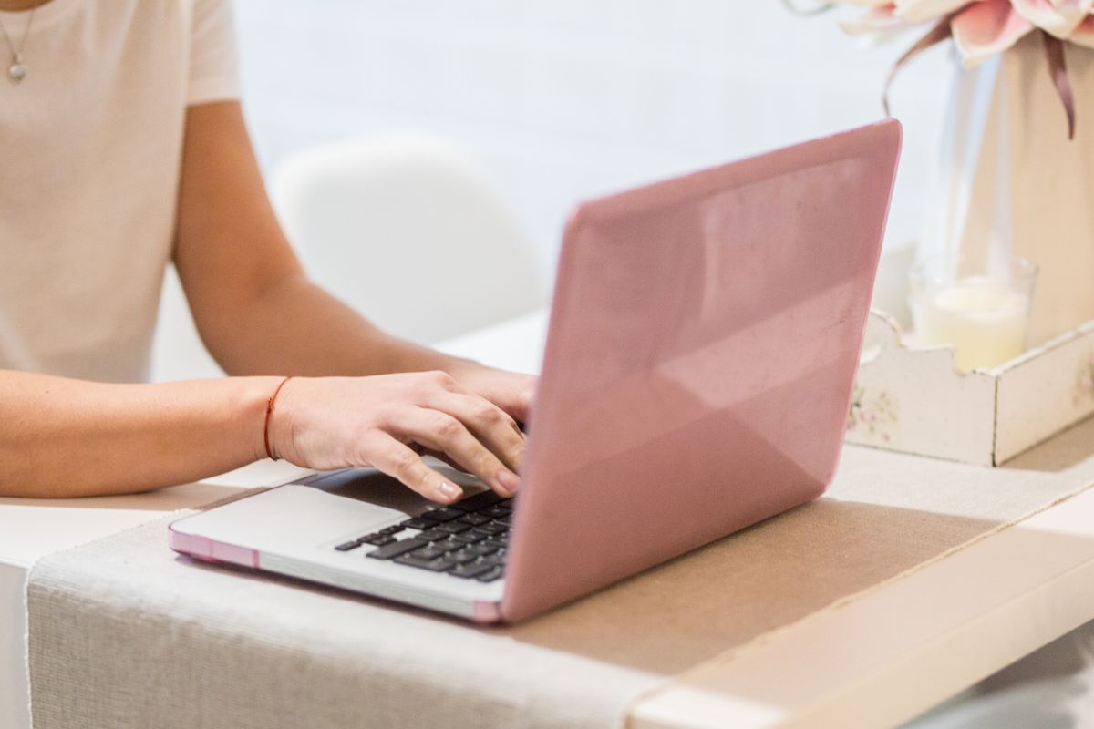 The photo is about a girl working on a laptop as a content moderator.