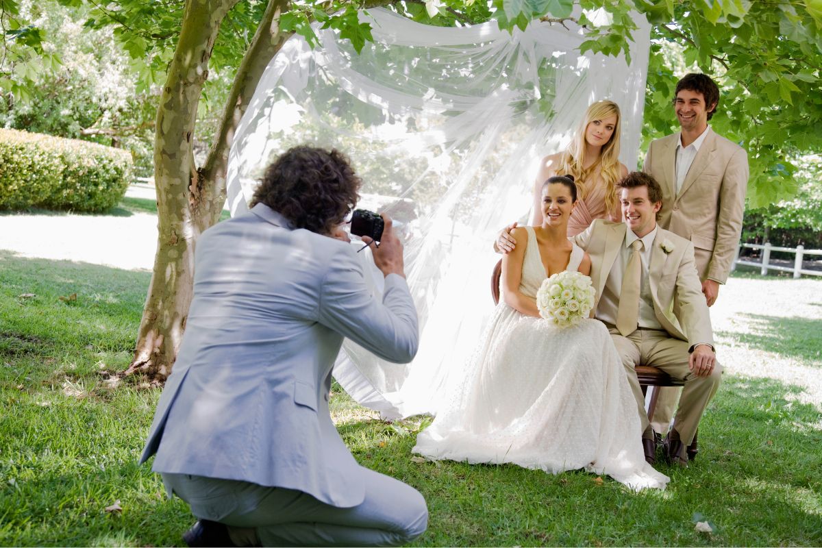 A photographer taking pictures of the bride and groom at the event.