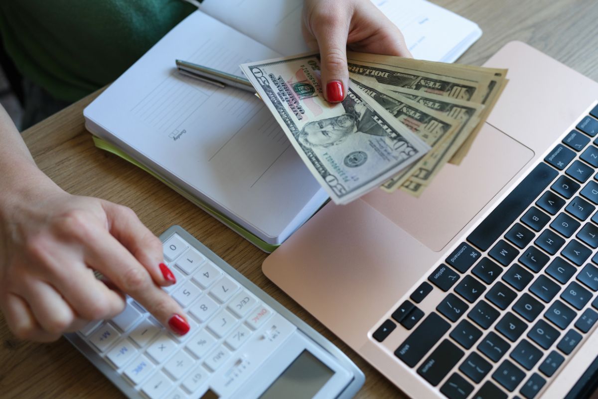 A picture of someone calculating her money.
