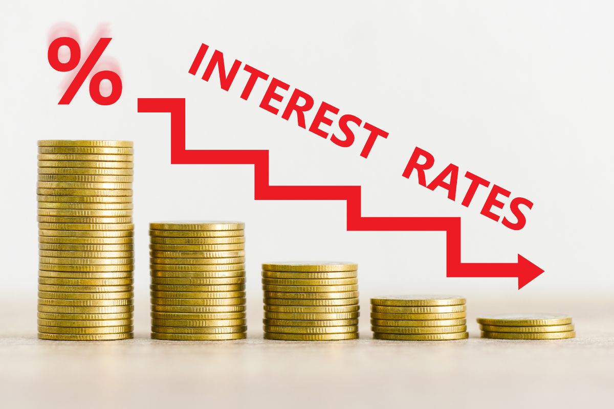A picture of coins and an illustration of lower interest. 