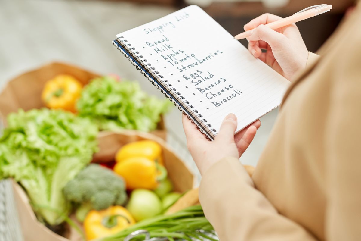 A picture of a woman with a grocery list. 