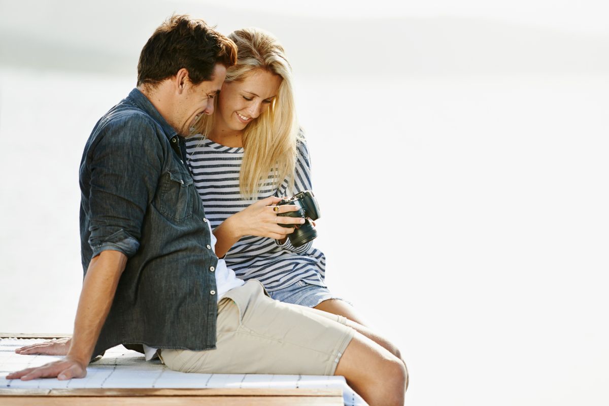 A picture of a couple with a camera. 