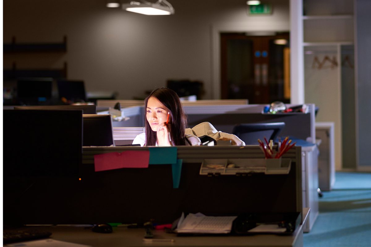 A picture of a woman doing overtime.