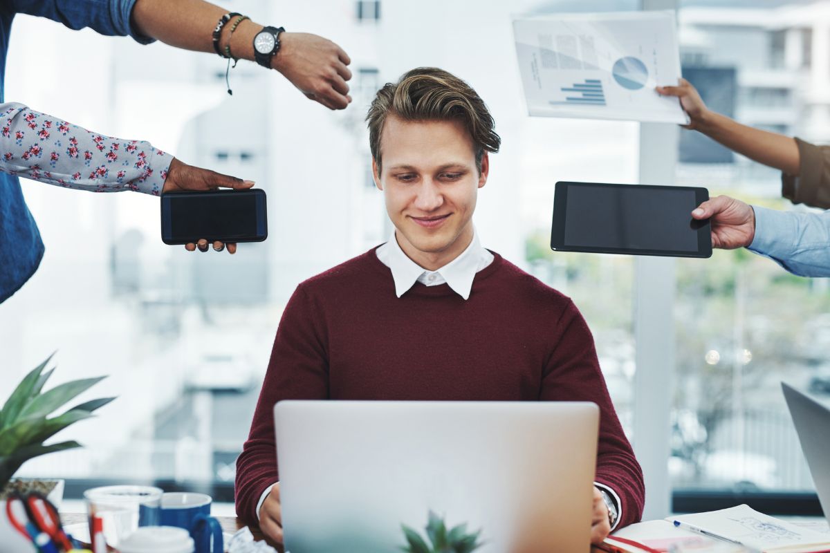 A picture of a man looking at a laptop.