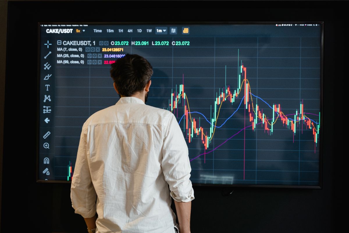 A picture of someone looking at a graph. 
